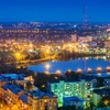 Night view of the city of Donetsk from a great height, a river in the center and a bridge over it