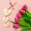 pink and purple tulips on a pink background and ceramic hearts with the inscription Dream, Hope, Wis