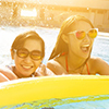 Happy family playing in swimming pool