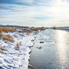Winter landscape by a river during sunset