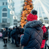 girl in red hat standing at street and drinking hot coffee outdoors in winter snow day