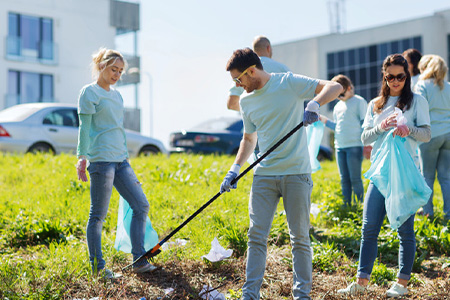 Volunteers picking up trash in community