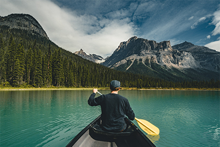 Young Man Canoeing on Emerald Lake