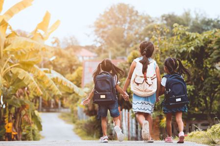 Back to school. Asian pupil kids with backpack going to school together in vintage color tone