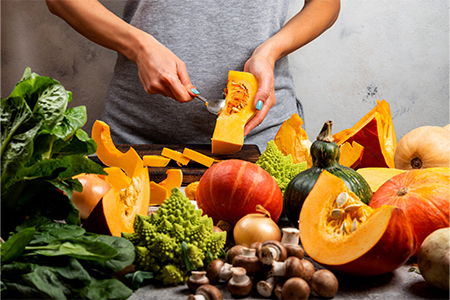 Woman prepare squash for cooking pumpkin dish. Close-up.