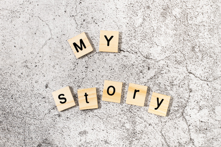 My Story written with wooden letter blocks on a stone background