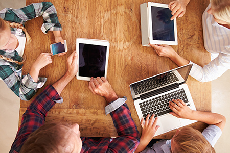 Family using new technology, overhead view