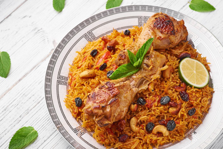 Chicken Kabsa or Chicken Biryani at white wooden background. Kabsa is traditional saudi arabian cuis