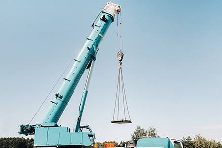 a large blue car crane prepared for an operation