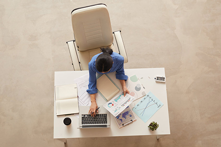  Top view background of businesswoman holding document while sitting at table, copy space