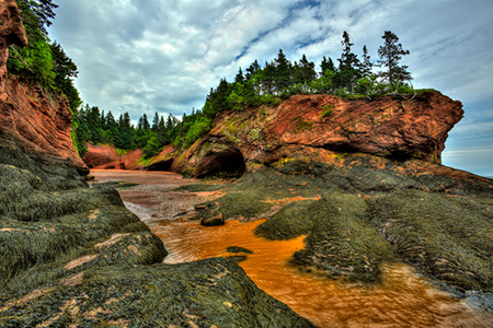 caves and coastal features at low tide of the Bay of Fundy at St. Martins, New Brunswick, Canada.