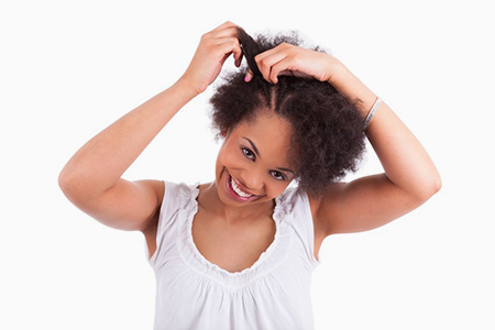 Young african american woman making braids, isolated on white background