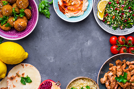 Assorted middle eastern dishes and meze background. tabbouleh, meat shawarma, hummus bowl, falafel, 