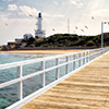 Clean beach with lighthouse in background