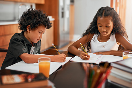 Shot of kids doing their homework together