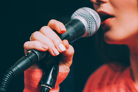 womans mouth close up near mic