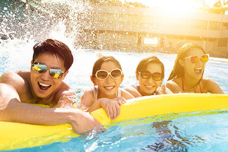 Happy family playing in swimming pool