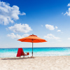 Orange umbrella on the clean beautiful beach and sea panorama with blue sky with couple white clouds