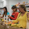 senior woman buying fresh fruits at mini market