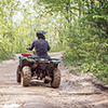 Man on the ATV Quad Bike on the mountains road.