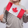 cropped view of person holding canada flag