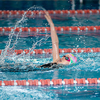 Swimmer child swims backstroke swimming style in the pool