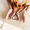 cropped image of african american mother and daughter preparing cookies with heart shaped mold in ki