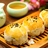 egg yolk puff and tea on bamboo plate