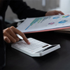 Woman with financial report and calculator to calculate report at the table in office.