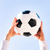 close up of hands holding a soccer ball, concept of football and sport, copy space for text
