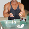 a muscular man holding a syringe and a vile of what looks like steroids