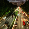 view from the top of a busy avenue, with cars speeding by