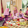 Muslim family praying before meal