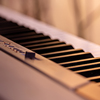 Piano keys on a beautiful colored background - Close up.