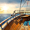 Wooden sailboat in the sea at sunrise