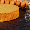 Soft sponge cake with ingredients: brown eggs, flour and whisk