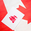 white card with family icon on canadian flag, immigration concept