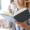 Asian woman reading at a cafe